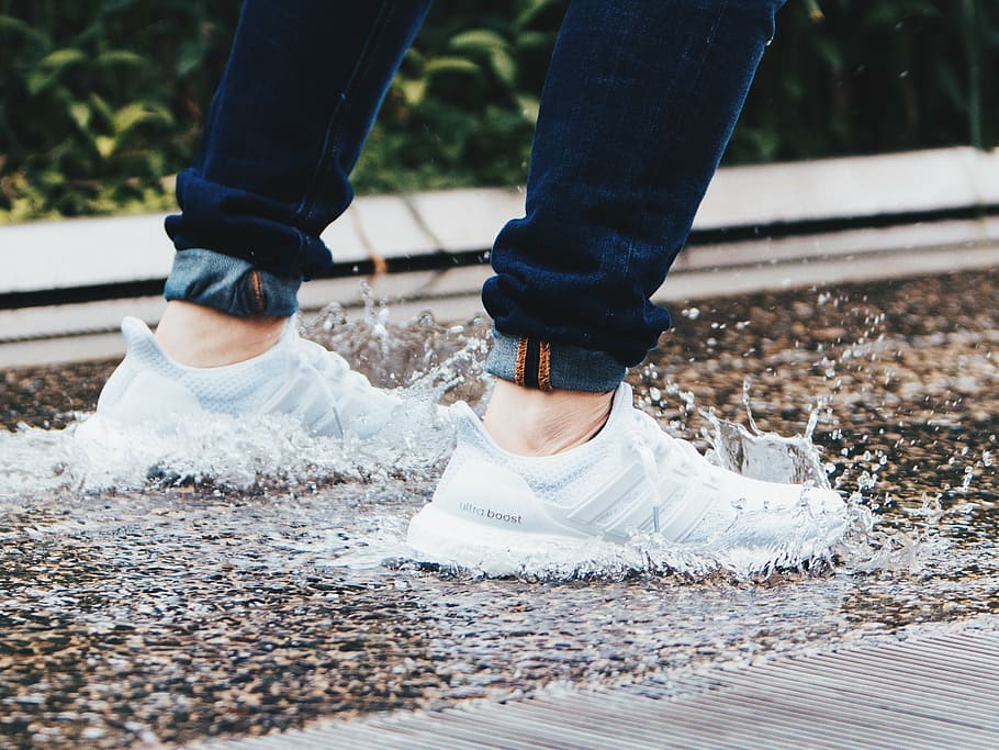 Person Wearing Pair Of White Adidas 